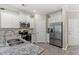 Kitchen with stainless steel appliances, grey wood-look floors, and white cabinets at 448 Papyrus Circle # 448, Little River, SC 29566