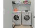This laundry room features a front load washer and dryer and wire shelving at 448 Papyrus Circle # 448, Little River, SC 29566