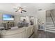 Open-concept living room with kitchen, stainless steel appliances, island with breakfast bar, and tv at 448 Papyrus Circle # 448, Little River, SC 29566
