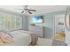 Bright bedroom with a ceiling fan, TV, and shutter blinds at 448 Papyrus Circle # 448, Little River, SC 29566