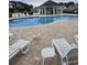 Community pool area with lounge chairs, tables, and a covered pavilion for relaxation and enjoyment at 448 Papyrus Circle # 448, Little River, SC 29566