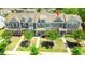 Aerial view of a two-story townhome with a well-manicured lawn and trees in a desirable community at 448 Papyrus Circle # 448, Little River, SC 29566