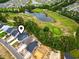 The aerial view captures the neighborhood's layout with its pond, golf course, and neatly arranged homes at 452 Sun Colony Blvd., Longs, SC 29568