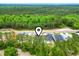 An aerial view captures this home nestled among the green trees and nearby community at 452 Sun Colony Blvd., Longs, SC 29568