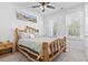 Bright bedroom featuring a unique wooden bed frame, two windows, and a ceiling fan at 452 Sun Colony Blvd., Longs, SC 29568