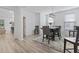 Bright dining room featuring stylish furnishings, wood-look floors and neutral walls at 452 Sun Colony Blvd., Longs, SC 29568