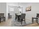 Well-lit dining room featuring modern chandelier, neutral walls and wood-look floors at 452 Sun Colony Blvd., Longs, SC 29568