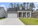 Charming single-Gathering home featuring blue siding, dormer windows and a two-car garage at 452 Sun Colony Blvd., Longs, SC 29568