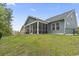 The home boasts a large screened porch and an expansive backyard with lush green grass at 452 Sun Colony Blvd., Longs, SC 29568