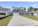 A well-maintained home with a long driveway and green lawn, set between neighboring residences at 452 Sun Colony Blvd., Longs, SC 29568