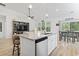 Kitchen island with granite countertops, seating, stainless dishwasher, and view of the living area at 452 Sun Colony Blvd., Longs, SC 29568