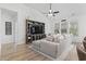 Inviting living room with large sectional sofa, wood flooring, and a built-in entertainment center at 452 Sun Colony Blvd., Longs, SC 29568