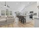 Open concept living space with vaulted ceilings, kitchen island, and comfortable seating at 452 Sun Colony Blvd., Longs, SC 29568