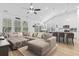 Bright open-concept living space with plush sectional sofa and bar seating at kitchen island at 452 Sun Colony Blvd., Longs, SC 29568
