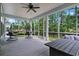 Relaxing screened porch with comfortable seating and views of the backyard and surrounding greenery at 452 Sun Colony Blvd., Longs, SC 29568