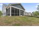 Backyard with a screened-in porch and a well-maintained lawn at 452 Sun Colony Blvd., Longs, SC 29568
