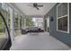 Inviting screened porch with neutral outdoor furniture and ceiling fan at 452 Sun Colony Blvd., Longs, SC 29568