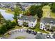 Aerial view of condo building with lush landscaping, parking, and a view of the golf course at 453 Red River Ct. # 38 I, Myrtle Beach, SC 29579