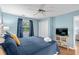 Comfortable bedroom featuring a cozy bed, bright window, ceiling fan, and a TV at 453 Red River Ct. # 38 I, Myrtle Beach, SC 29579