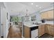 Bright kitchen with open layout, wood cabinets, and view to the living space and balcony at 453 Red River Ct. # 38 I, Myrtle Beach, SC 29579