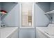 Laundry room area with washer and dryer hookups, shelving, and natural light from a window at 453 Red River Ct. # 38 I, Myrtle Beach, SC 29579