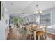 Open concept living and dining room with wood floors, ceiling fan and sliding glass door leading to screened in porch at 453 Red River Ct. # 38 I, Myrtle Beach, SC 29579