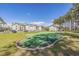 Scenic outdoor putting green with surrounding grassy area and views of the condo complex on a sunny day at 453 Red River Ct. # 38 I, Myrtle Beach, SC 29579