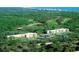 An aerial view of the building and surrounding community with pool, golf course, and ocean views at 5001 Little River Rd. # E-117-119, Myrtle Beach, SC 29577