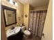 Bathroom with a vanity, toilet, decorative shower curtain and mirror, providing necessary features at 5001 Little River Rd. # E-117-119, Myrtle Beach, SC 29577