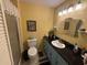 Well-lit bathroom featuring a vanity with sleek black countertop, and a shower with a glass door at 5001 Little River Rd. # E-117-119, Myrtle Beach, SC 29577