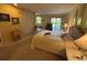 Spacious bedroom featuring a queen bed, access to a balcony and comfortable sitting area at 5001 Little River Rd. # E-117-119, Myrtle Beach, SC 29577