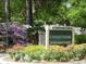Welcoming signage for Covenant Towers with surrounding colorful floral landscaping at 5001 Little River Rd. # E-117-119, Myrtle Beach, SC 29577
