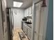 Galley kitchen with white cabinets, stainless steel refrigerator and tiled backsplash at 5001 Little River Rd. # E-117-119, Myrtle Beach, SC 29577