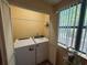 Bright laundry room featuring a washer, dryer, and window that provides natural light at 5001 Little River Rd. # E-117-119, Myrtle Beach, SC 29577