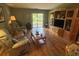 Cozy living room with hardwood floors, TV, entertainment center, and access to outdoor patio at 5001 Little River Rd. # E-117-119, Myrtle Beach, SC 29577