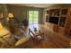 Comfortable living room with hardwood floors and access to outdoor patio at 5001 Little River Rd. # E-117-119, Myrtle Beach, SC 29577