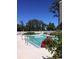 Outdoor pool surrounded by a fence and lush greenery on a sunny day at 5001 Little River Rd. # E-117-119, Myrtle Beach, SC 29577