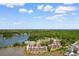501 Maison Dr: Aerial view showcasing waterfront living surrounded by lush greenery and tranquil waterway at 501 Maison Dr. # F14, Myrtle Beach, SC 29572