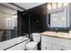 The bathroom features dark tile walls, a white vanity, and an elegant shower with a glass partition at 501 Maison Dr. # F14, Myrtle Beach, SC 29572