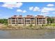 Exterior shot of a large waterfront building with multiple floors and balconies at 501 Maison Dr. # F14, Myrtle Beach, SC 29572