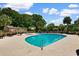 Exterior of community pool featuring an in-ground pool with chairs and tables at 501 Maison Dr. # F14, Myrtle Beach, SC 29572