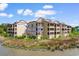 Exterior view of condominium complex featuring the balcony for Unit F14 with marsh view at 501 Maison Dr. # F14, Myrtle Beach, SC 29572
