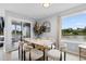 Bright dining area with a modern table set and views of the waterfront through a large window at 501 Maison Dr. # F14, Myrtle Beach, SC 29572