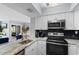 Open-concept kitchen with modern appliances and a dining area in the background at 501 Maison Dr. # F14, Myrtle Beach, SC 29572