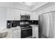Modern kitchen with stainless steel appliances, white cabinets, and stylish countertops at 501 Maison Dr. # F14, Myrtle Beach, SC 29572