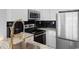 Modern kitchen with stainless steel appliances, white cabinets, and granite countertops at 501 Maison Dr. # F14, Myrtle Beach, SC 29572