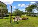 Outdoor picnic area with wooden benches and tables, grill and mature trees at 501 Maison Dr. # F14, Myrtle Beach, SC 29572
