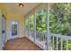 Inviting balcony with wood-look flooring and white railings overlooks lush green trees at 5038 Belleglen Ct. # 202, Myrtle Beach, SC 29579