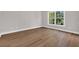 Bedroom features a large window letting in natural light and hardwood floors at 5038 Belleglen Ct. # 202, Myrtle Beach, SC 29579