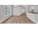 Dining area with natural light, showcasing wood flooring and a view of the kitchen at 5038 Belleglen Ct. # 202, Myrtle Beach, SC 29579
